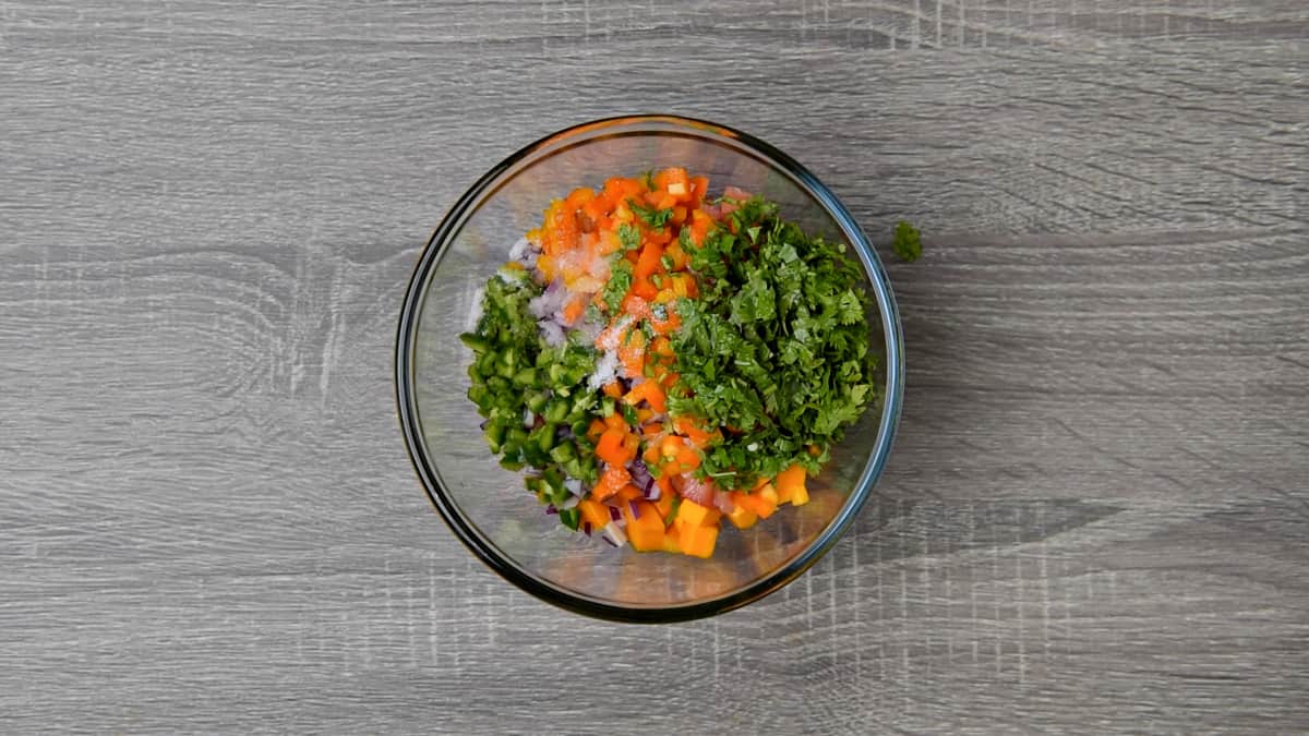 sweet peppers, jalapeño, cilantro, lime juice, and salt added to bowl with salsa ingredients