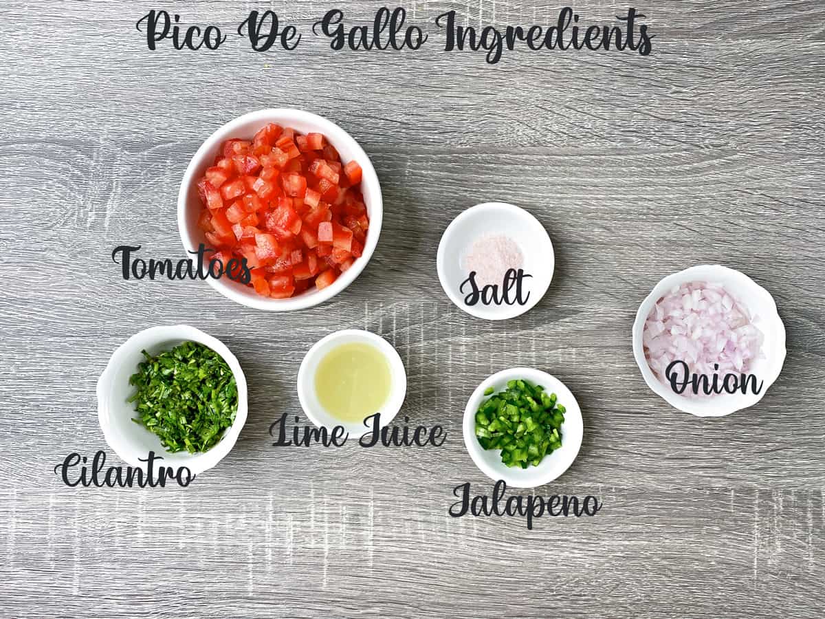 ingredients for making pico de gallo measured out in white bowls on a grey table