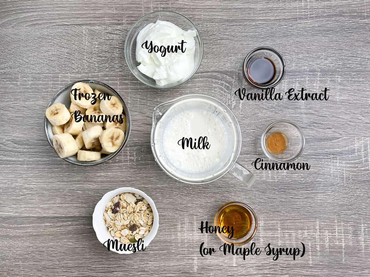 ingredients for making healthy breakfast smoothies measured out into bowls on a table