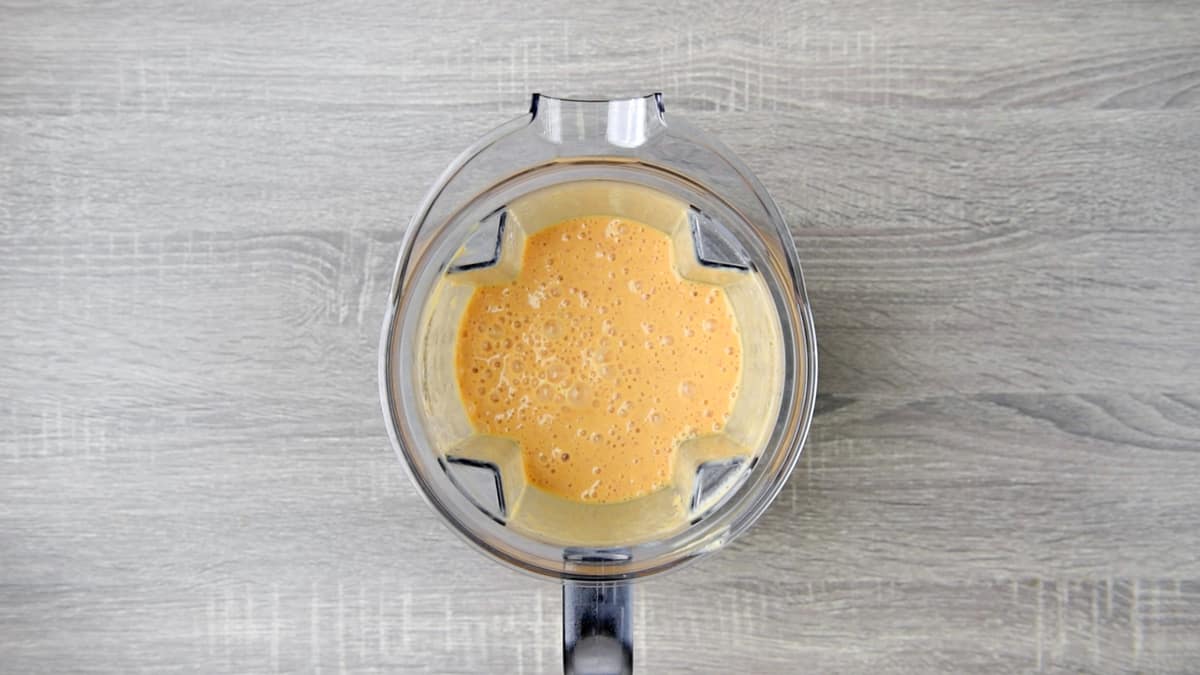 mango peach smoothie in pitcher after blending