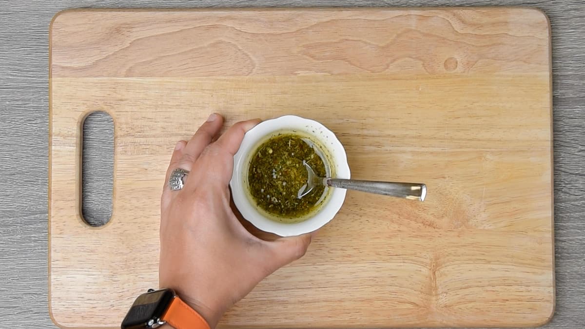 herb and oil mixture in a small mixing bowl