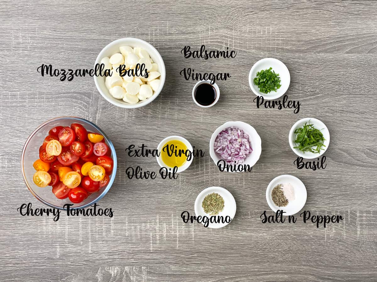 ingredients to make tomato mozzarella salad measured out into bowls