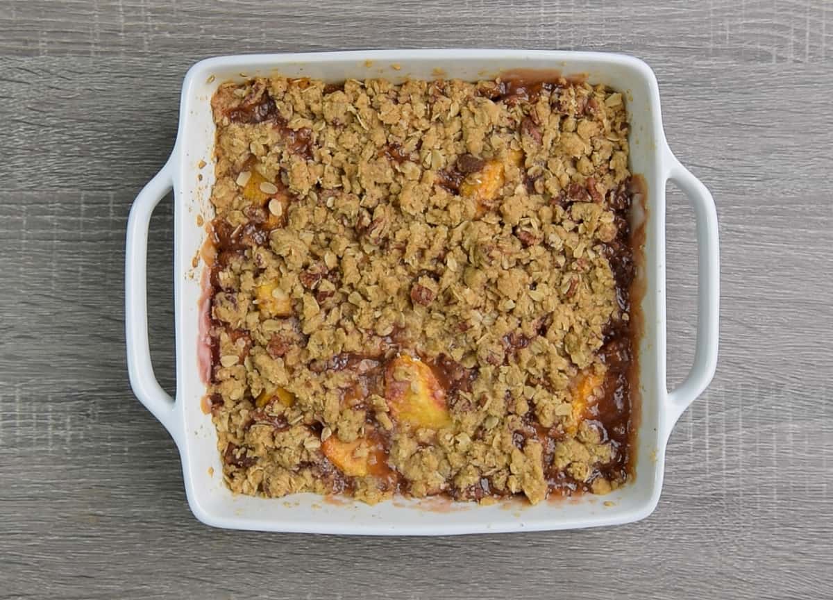 baked peach crisp in casserole dish