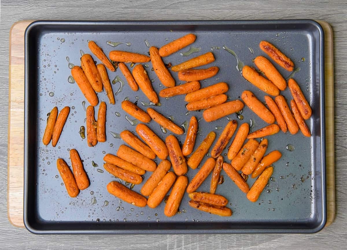 roasted maple baby carrots on a sheet pan