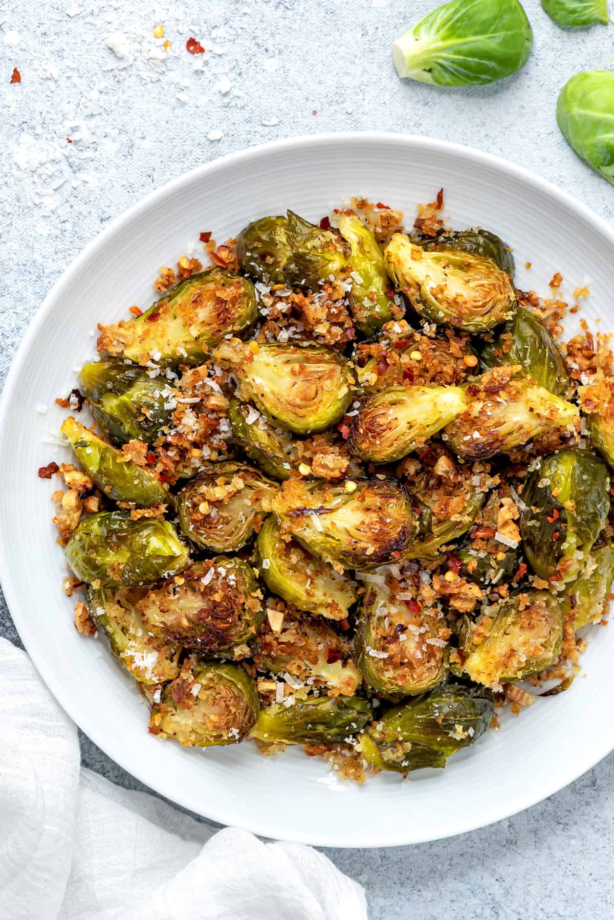 flat lay closeup of a serving platter of roasted brussels sprouts with garlic and parmesan breadcrumbs
