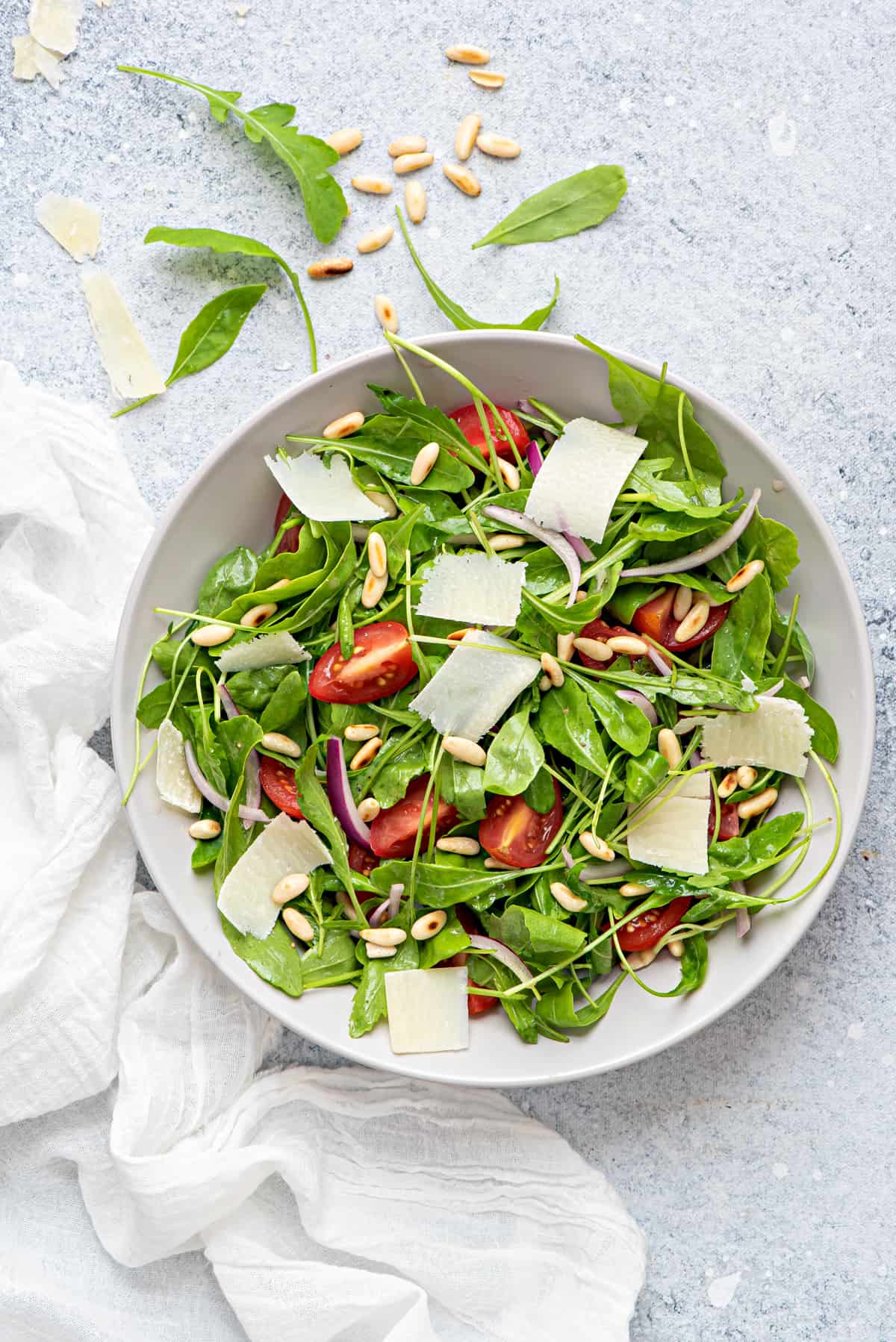Rocket Salad one bowl of arugula salad with pine nuts, parmesan, tomatoes, onions