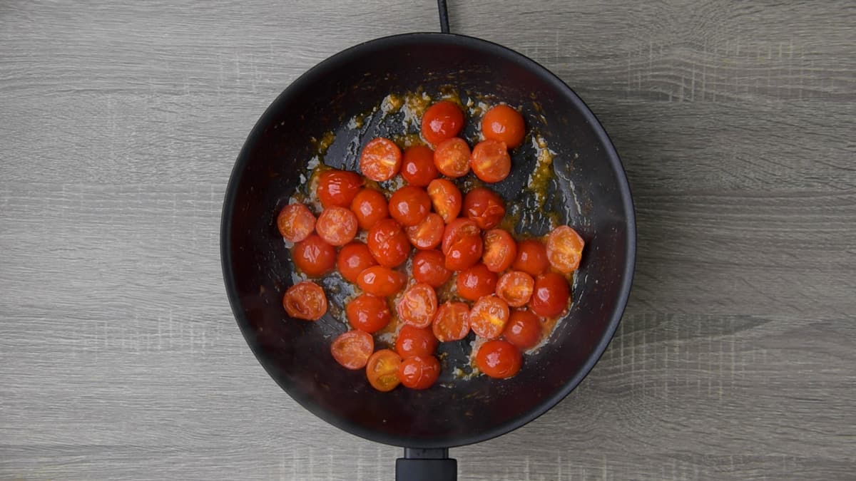 softening tomatoes in skillet with oil and garlic