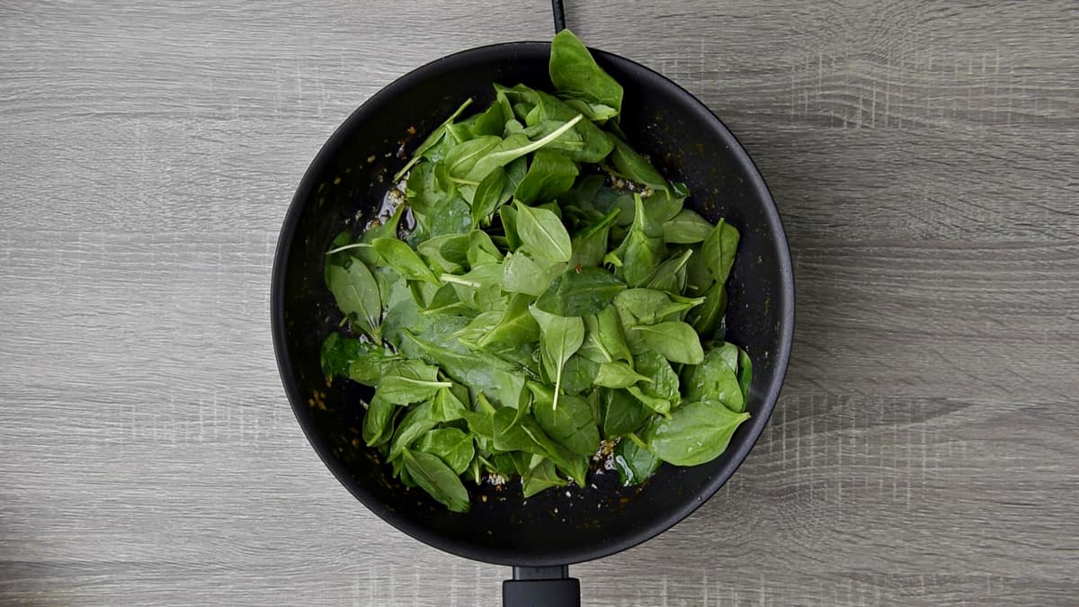 fresh spinach in skillet 