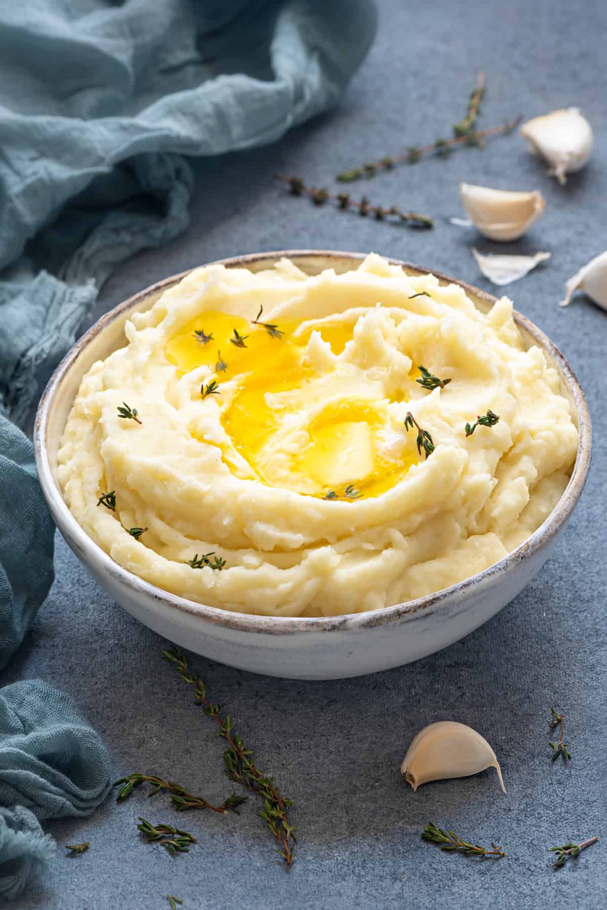 white bowl with mashed potatoes with roasted garlic and butter