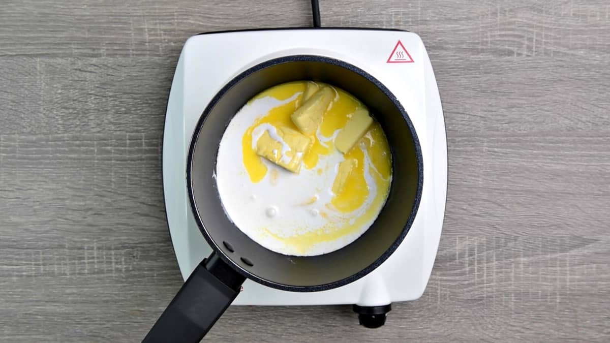 small sauce pan with butter and cream melting on medium heat