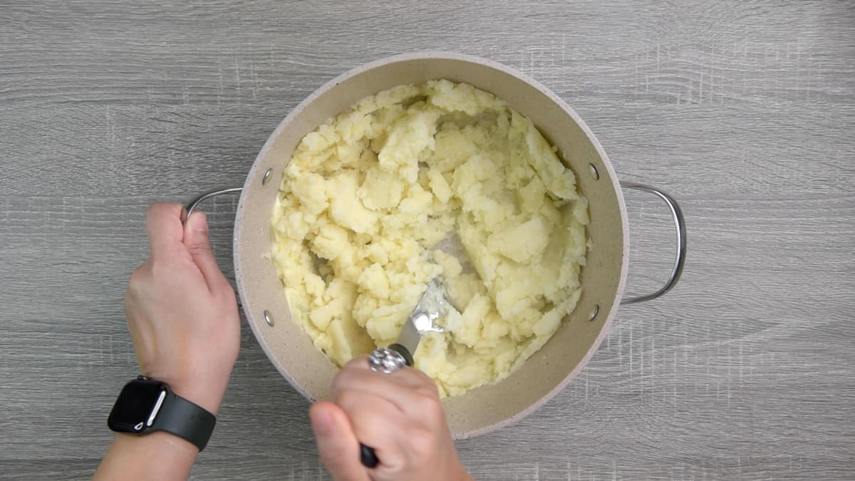 mashing potatoes with potato masher