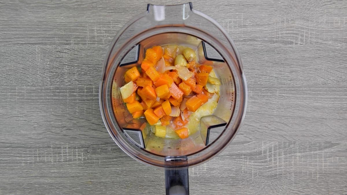 food processor with roasted vegetables, coconut milk and broth 