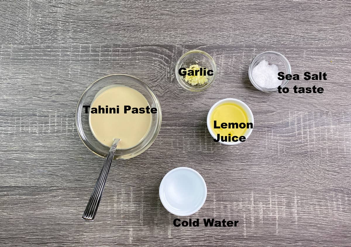 tahini paste, garlic, lemon juice, salt, and water in bowls 