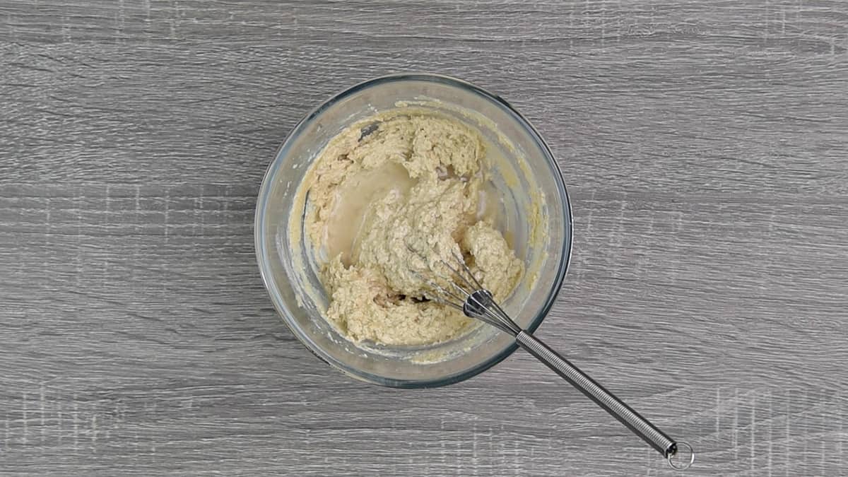 mixing tahini sauce in bowl with whisk