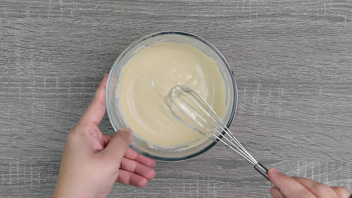 one bowl of creamy tahini sauce with whisk 
