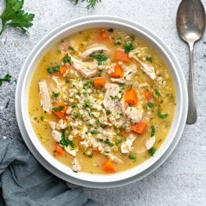 one white bowl with chicken barley soup