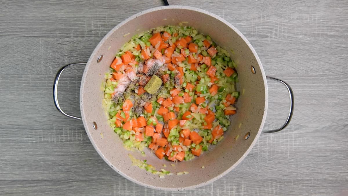 carrots, celery, onion, garlic, chicken stock cube, salt, pepper cooking in pot 