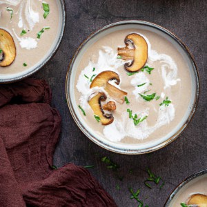 two bowls of cream of mushroom soup with mushrooms and cream