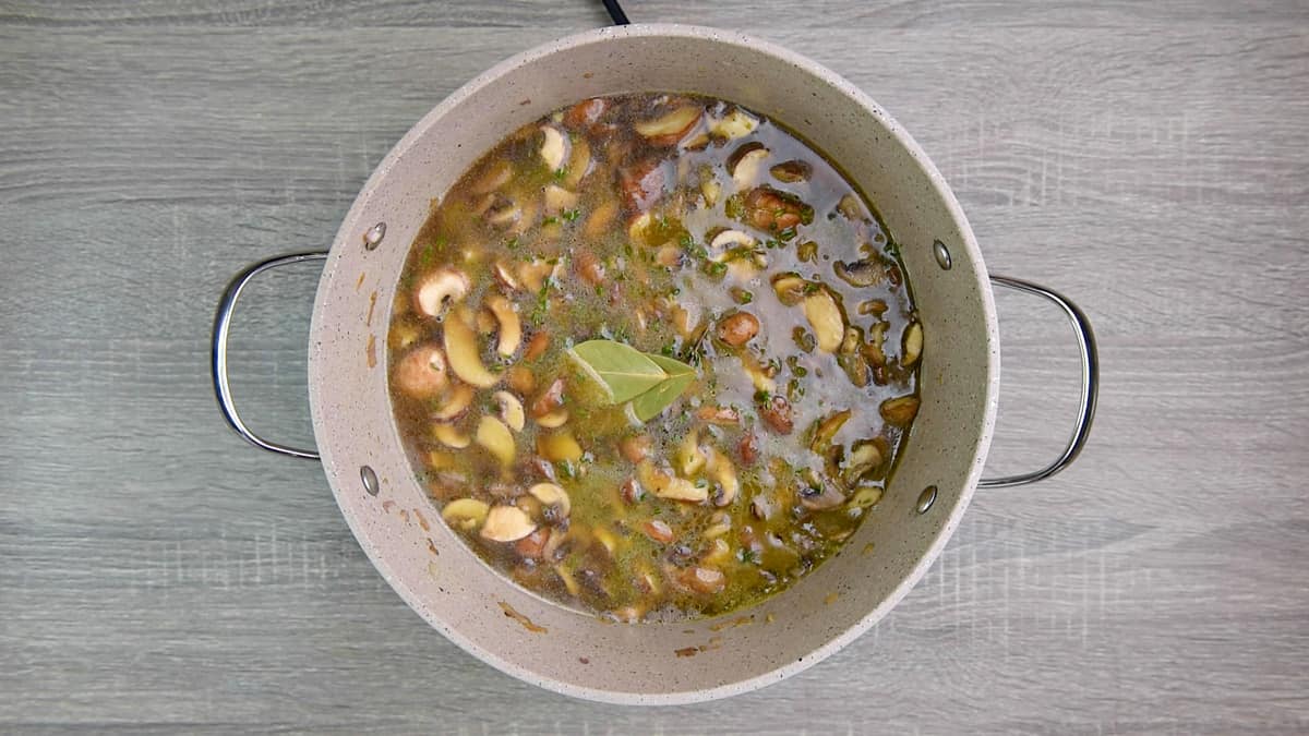 pot with mushrooms, veggies, and broth 