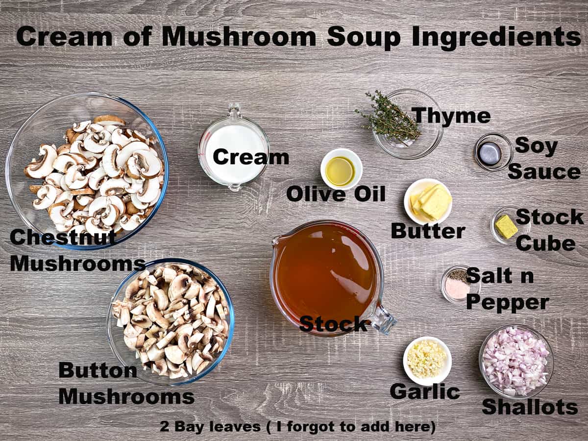 mushrooms, cream, olive oil, butter, thyme, soy sauce, stock cube, shallots, garlic, and stock in bowls on wooden surface