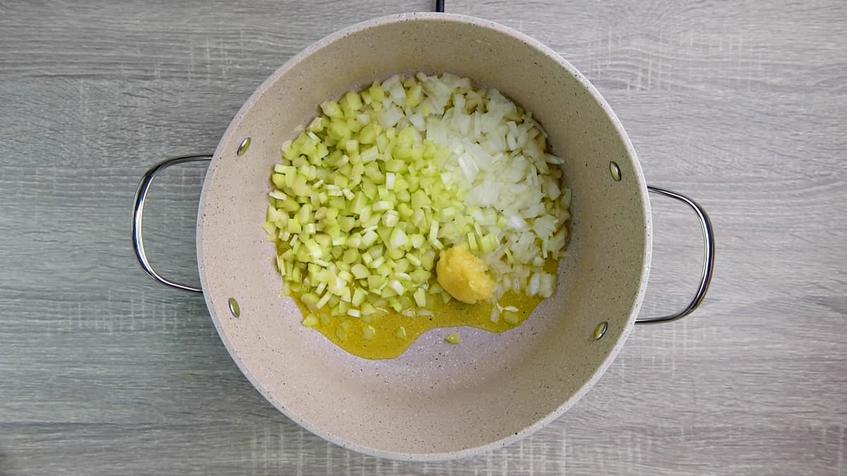 cooking celery, garlic, and onion in oil in pot 