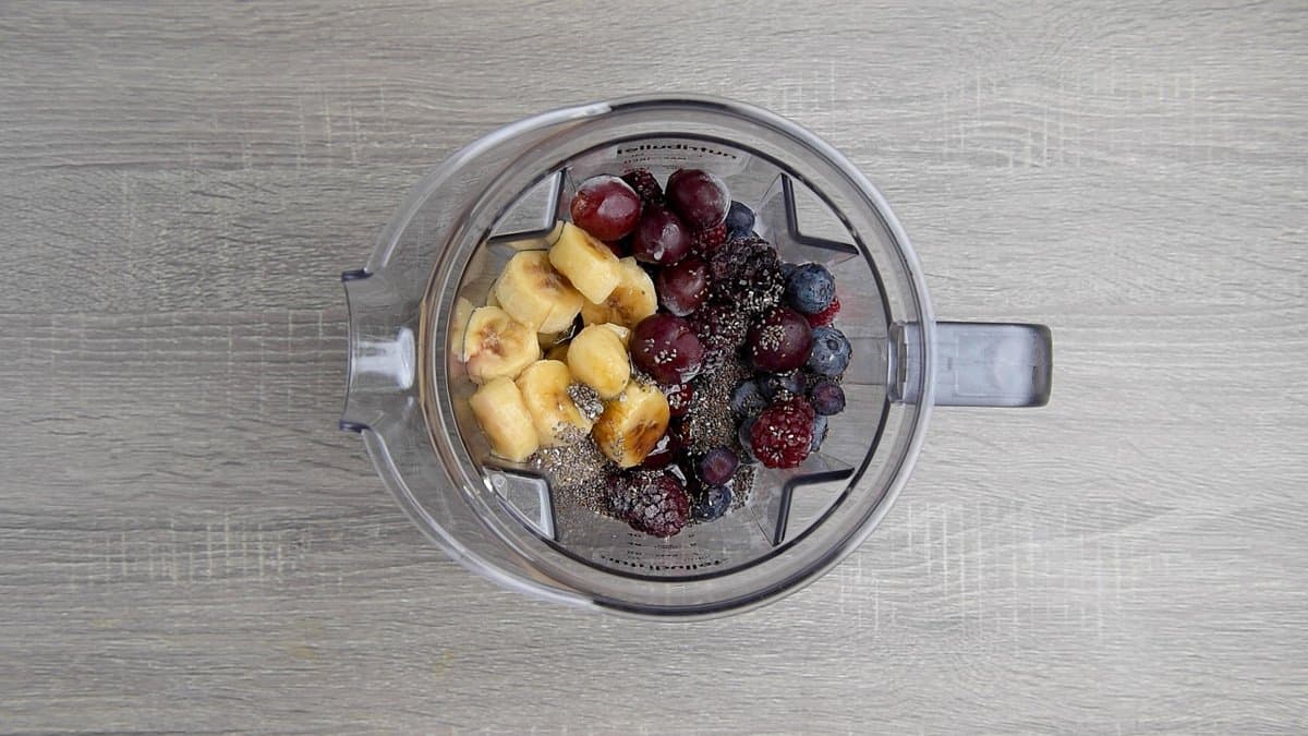 almond milk, frozen berries, fruits, chia seeds and flavorings in blender.