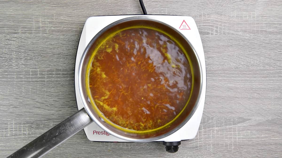 ginger and turmeric tea simmering in saucepan on low heat.