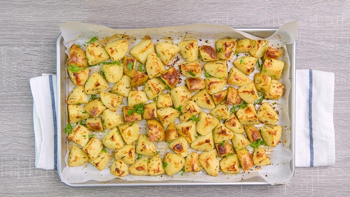 fully cooked rosemary potatoes on a pan ready to serve.