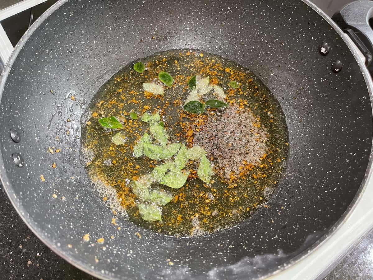 remaining oil heated in the same pan, added curry leaves, mustard seeds in it.