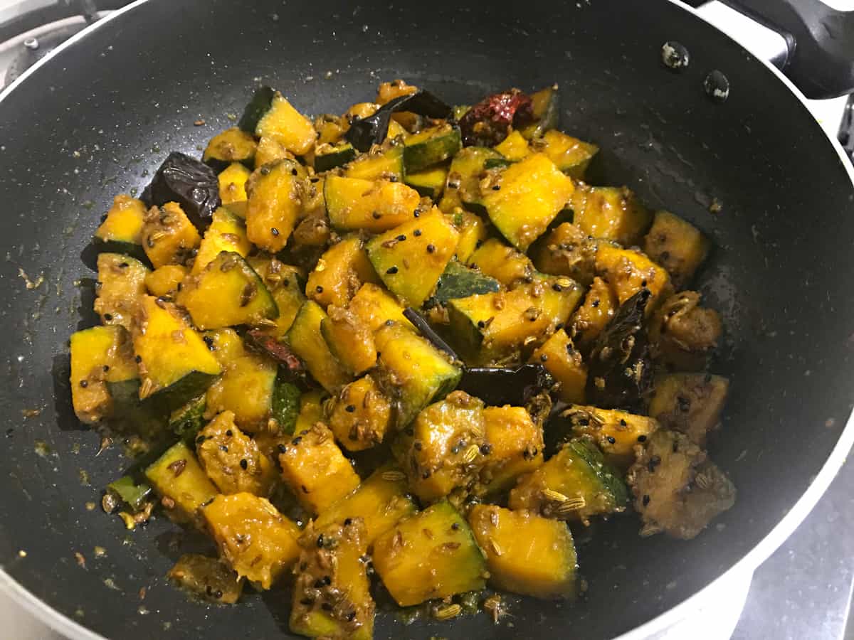 Fully cooked pumpkin sabzi in kadai is ready to served.