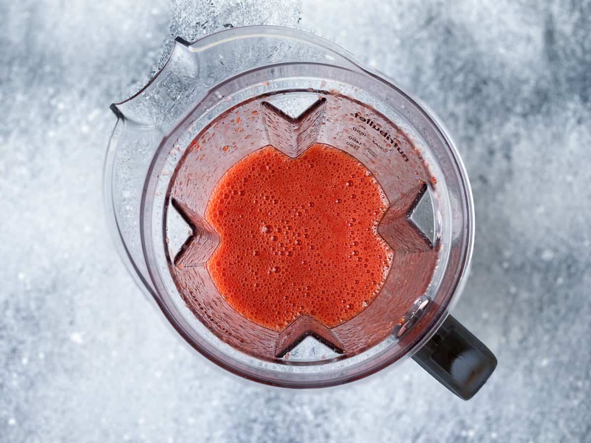 Blended strawberries juice in a blender jar.