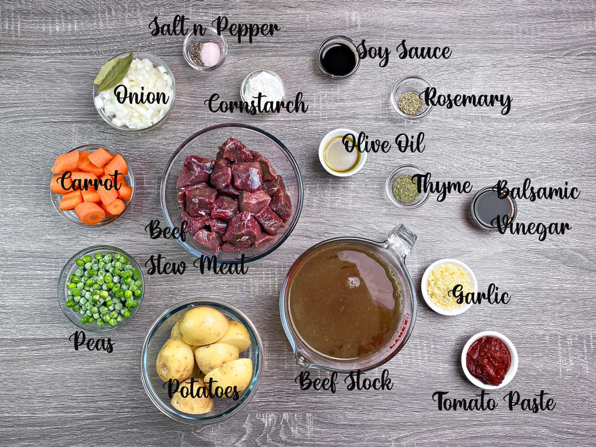 Ingredients to make instant pot beef stew measured correctly in bowls and laid on a table.