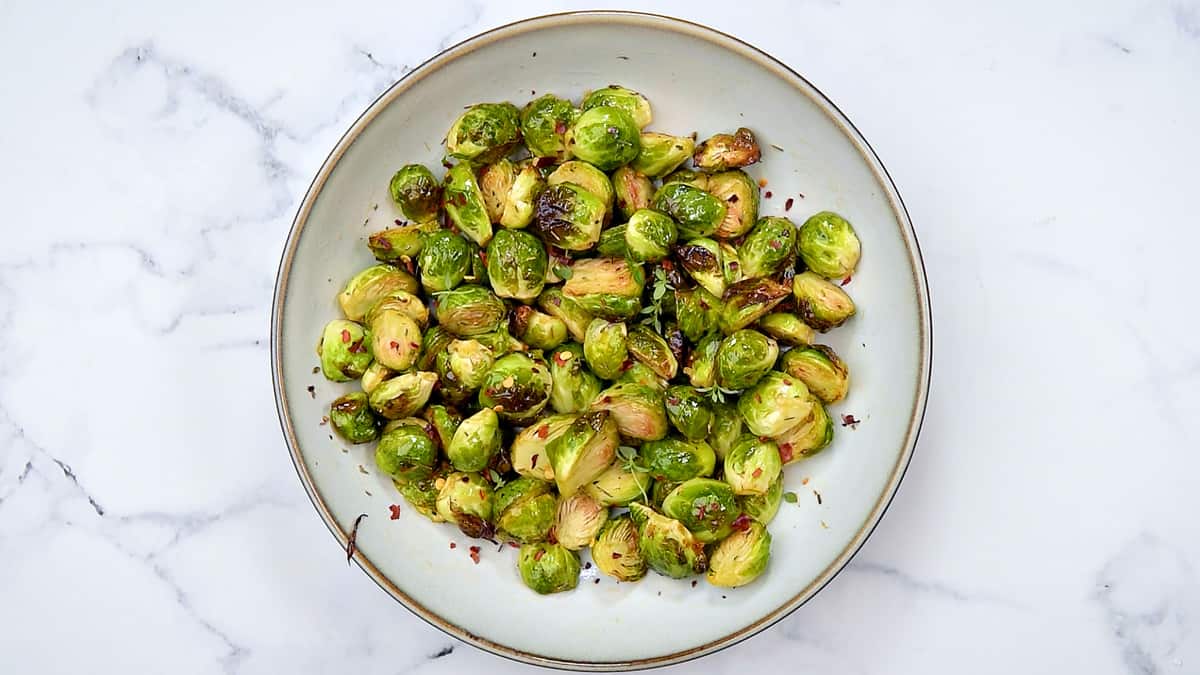 Air fried brussel sprouts on a large circle platter.