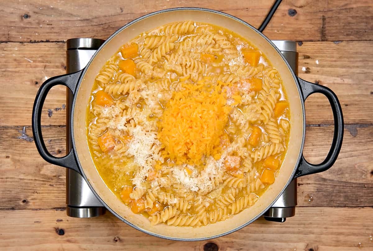 Grated parmesan, and sharp cheddar cheese added to the cooked pasta.