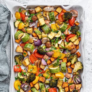 Top down shot of roasted vegetables on a baking sheet pan.
