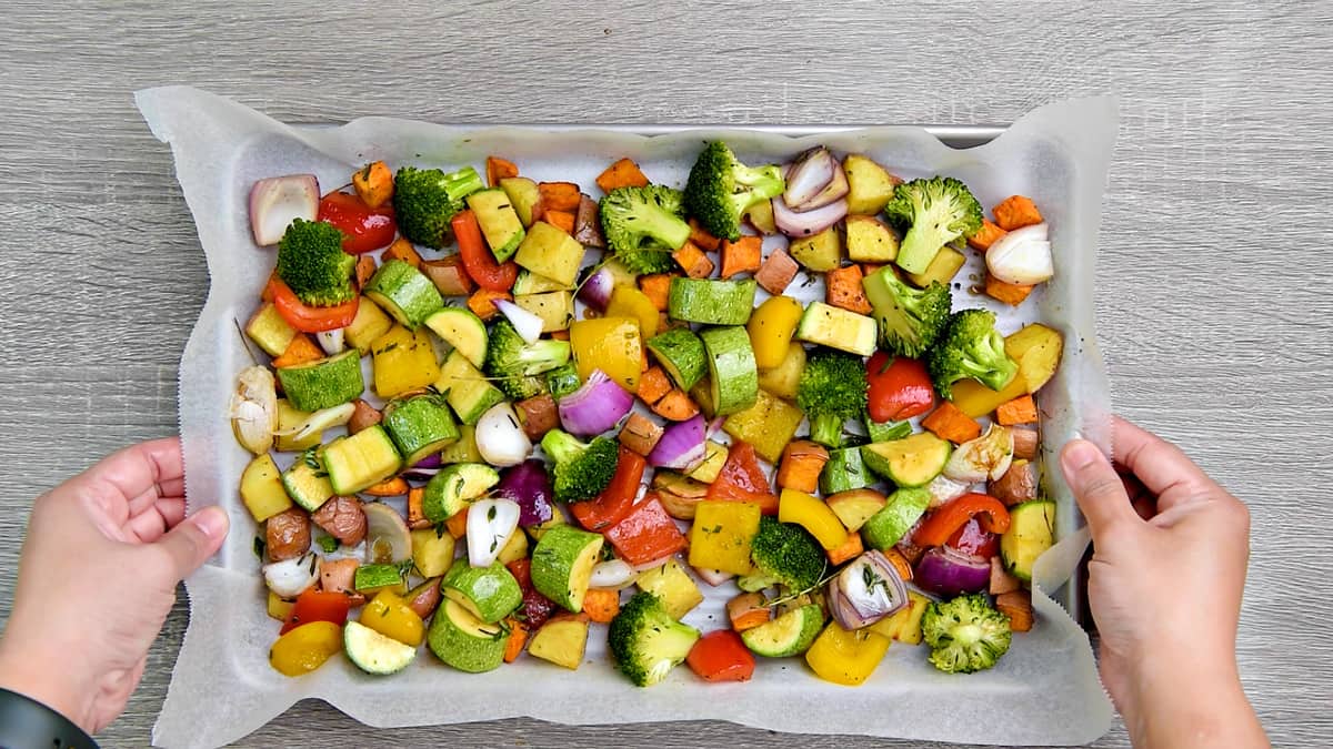 All the seasoned veggies added to the same baking sheet pan with potatoes.