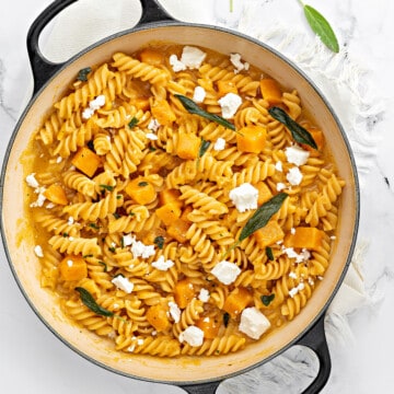 One pot pasta with butternut squash pasta sprinkled with crumbled feta cheese and fried sage.