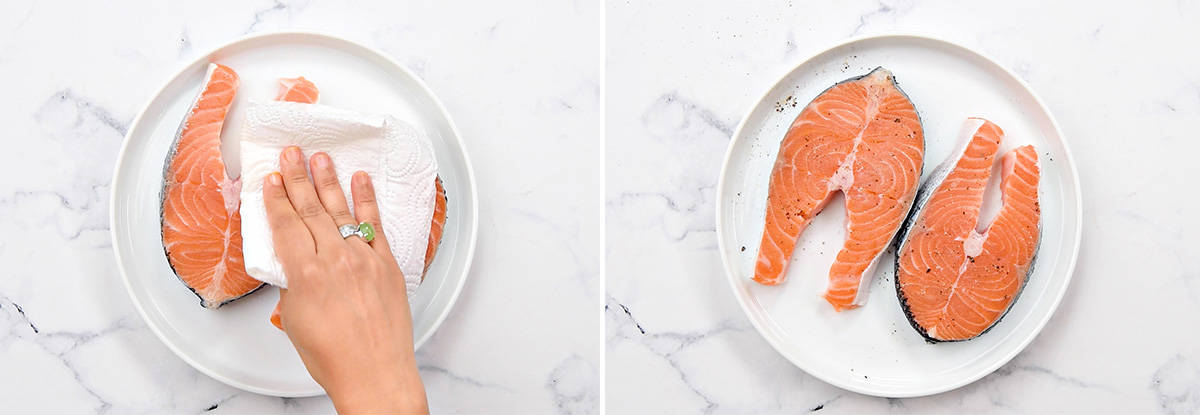 Hand patting two salmon steaks dry with a paper towel and seasoning with salt and pepper.