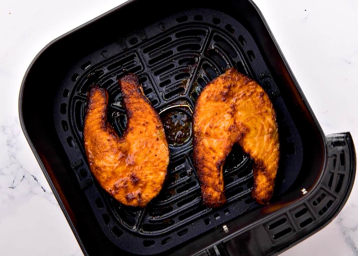 Crispy air fried salmon steaks in the basket.