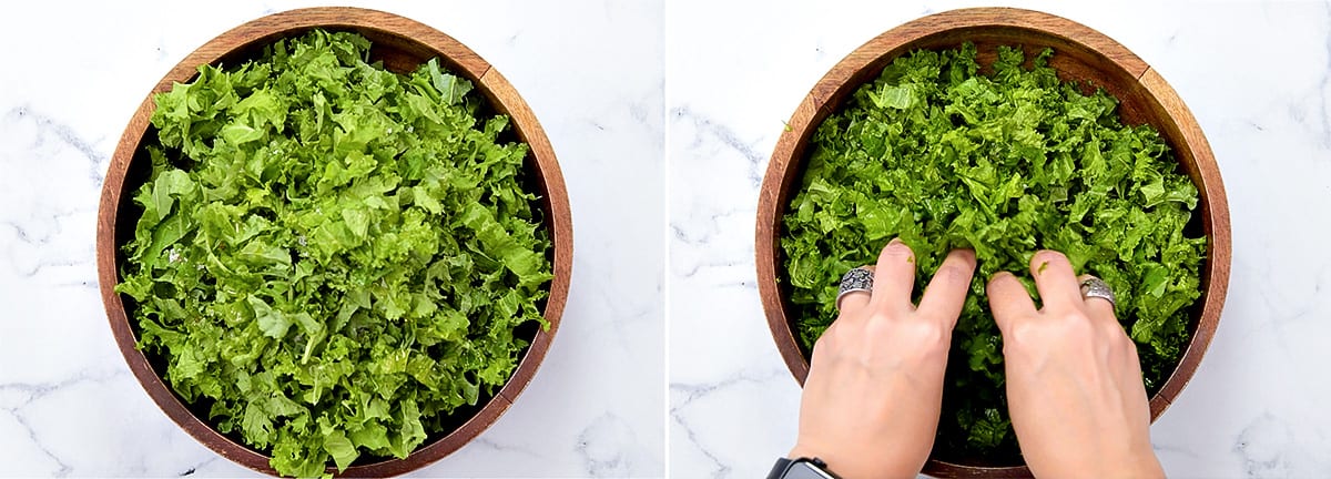 Hands massaging fresh kale leaves in a salad bowl.