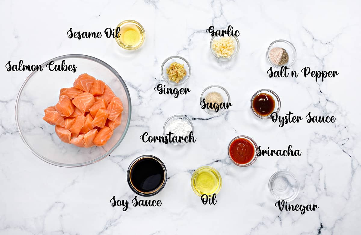 Individual glass dishes with all of the recipe ingredients laid on a white table.