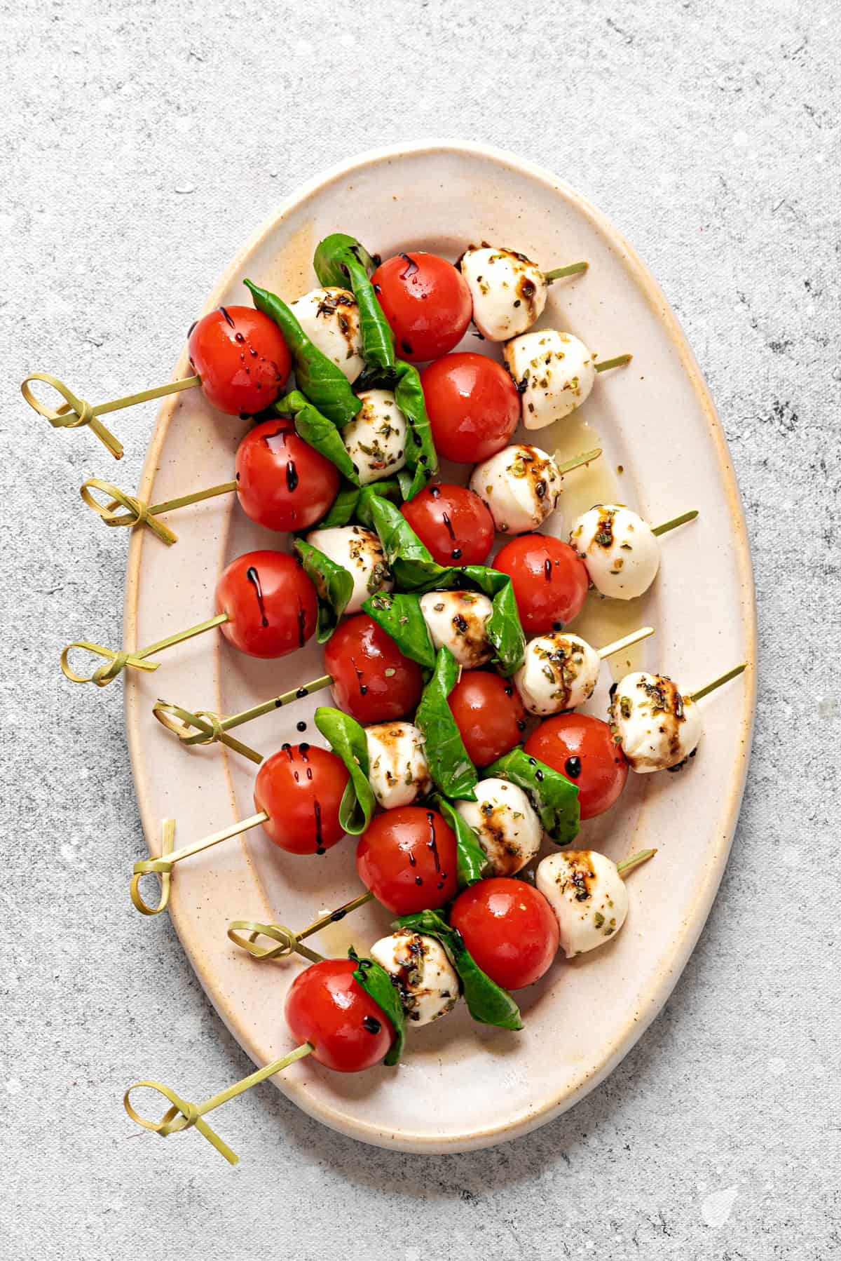 Large oval plate with 6 Caprese skewers.