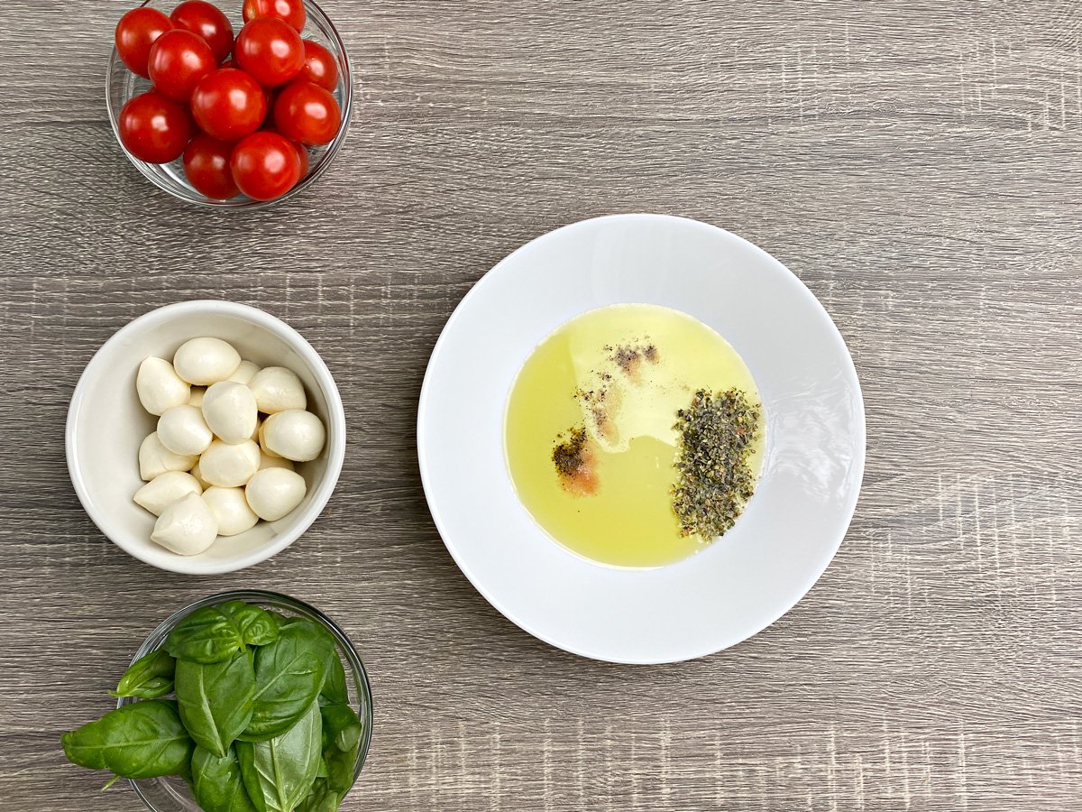 White bowl with oil and seasonings.