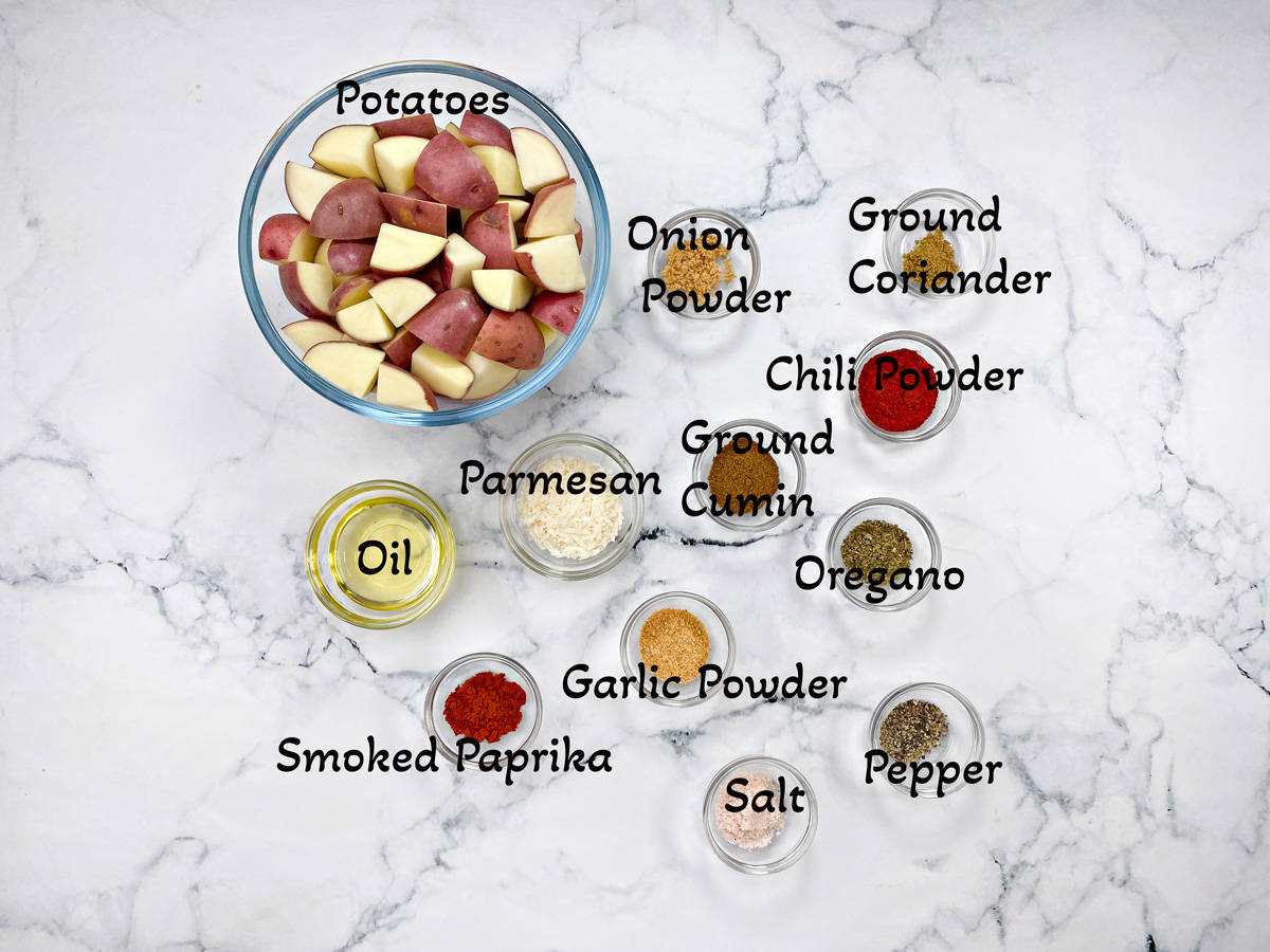 Recipe ingredients placed in individual glass bowls and laid on a white marble table.