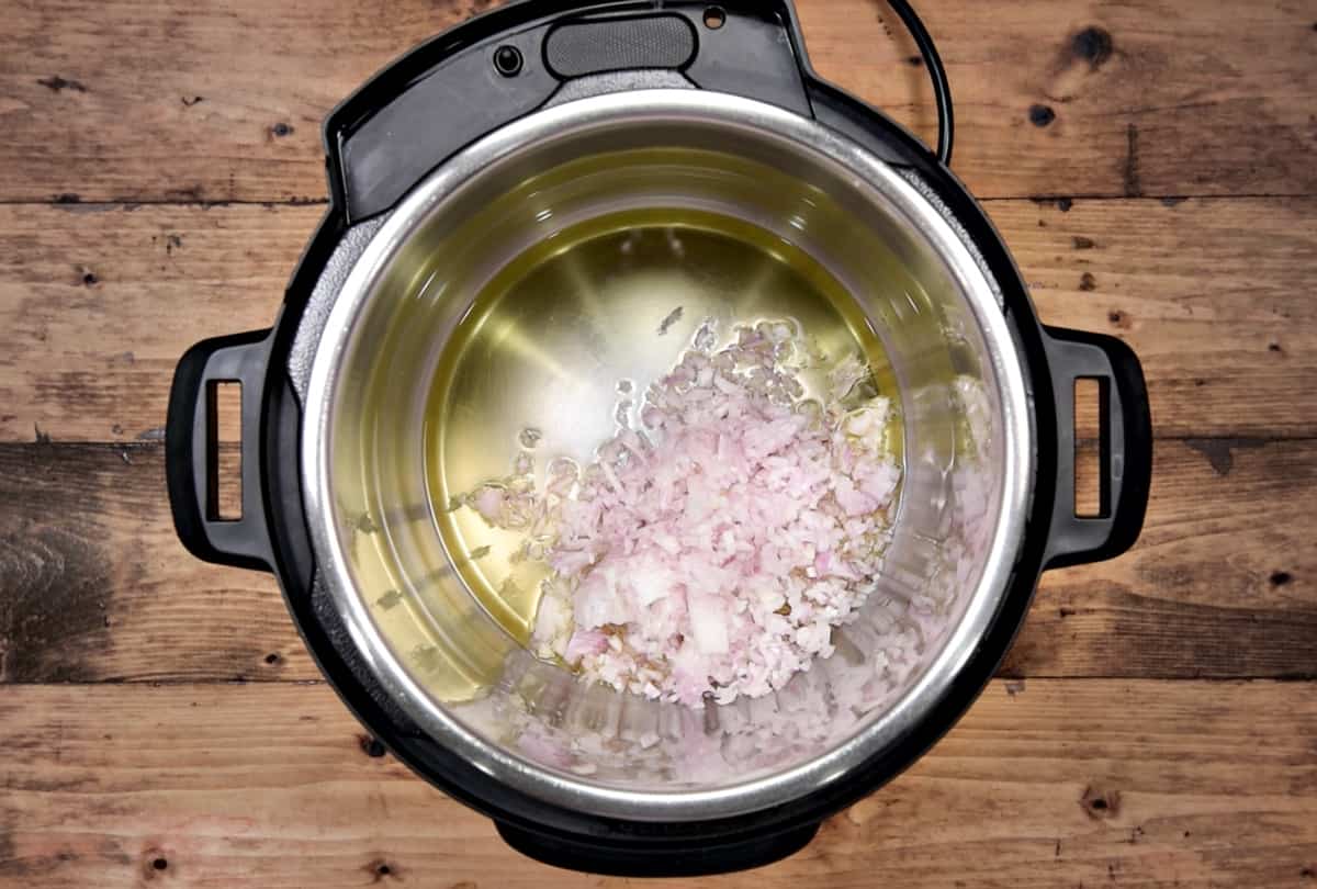 Chopped onion added to the hot oil in the instant pot.