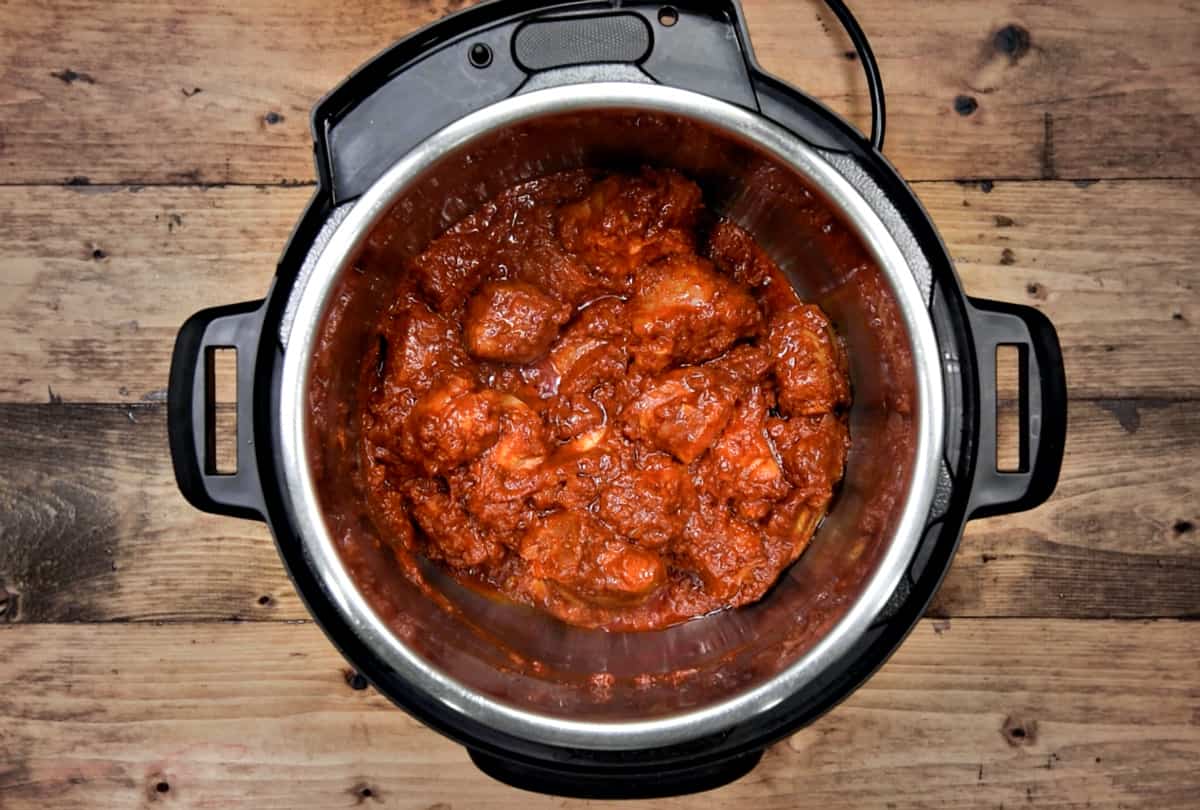 Marinated Lamb pieces frying in pot. 