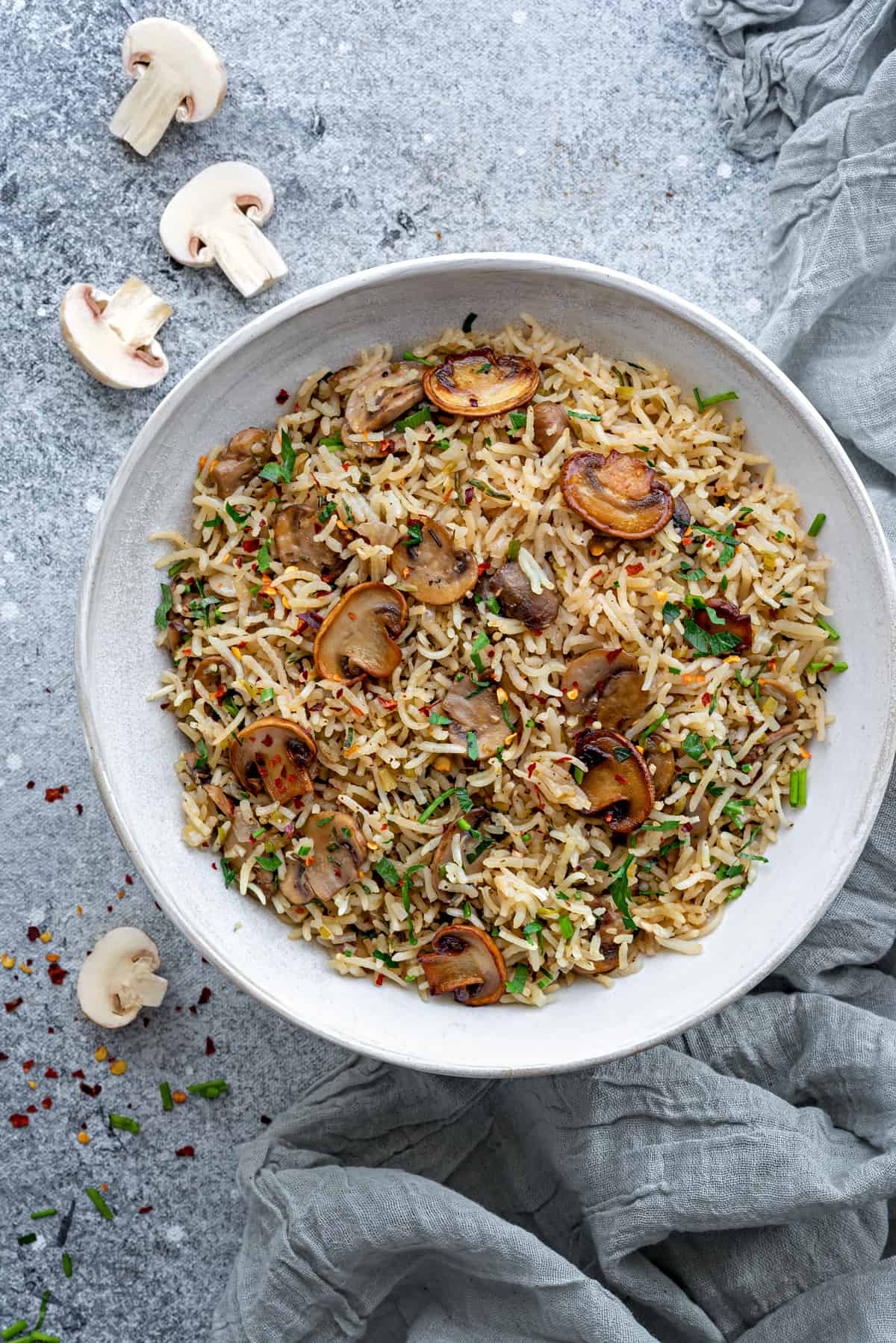 overhead view of white bowl with mushroom rice.