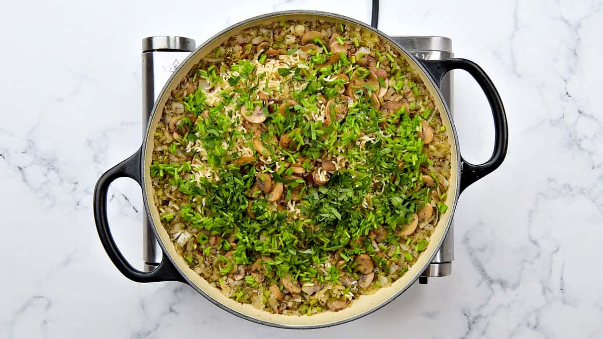 Fresh herbs added to garnish the pot of mushroom rice.