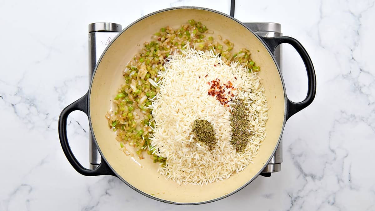 Rice, thyme, oregano and red pepper flakes added to the pot.