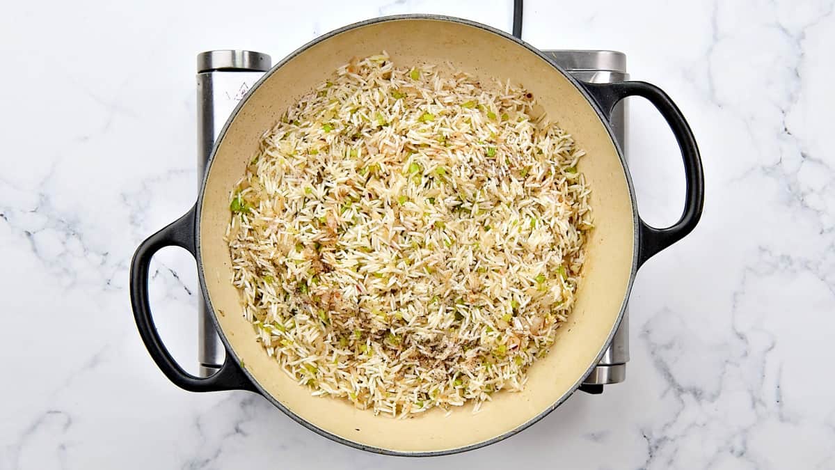 Soy sauce, salt and pepper added to the rice in the pot.